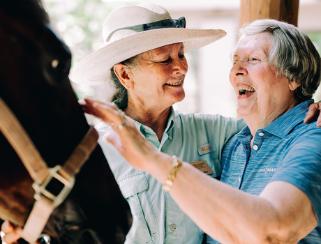 A resident petting a horse at The Hacienda at the River assisted living community in Tucson.