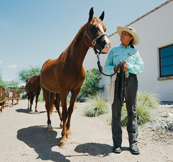 A resident and a horse at the stables at The Hacienda at the River.