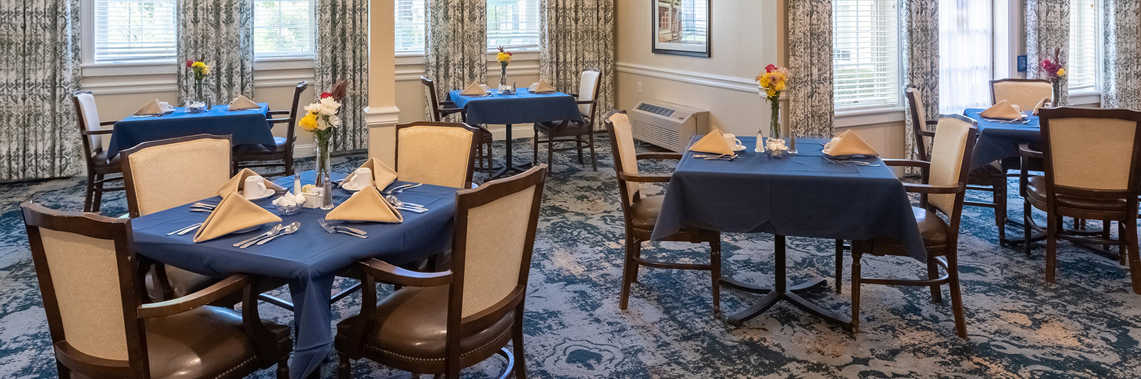 A dining room full of chairs and tables. A dining room full of chairs and tables.