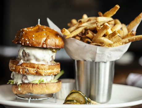 A large burger with fries.