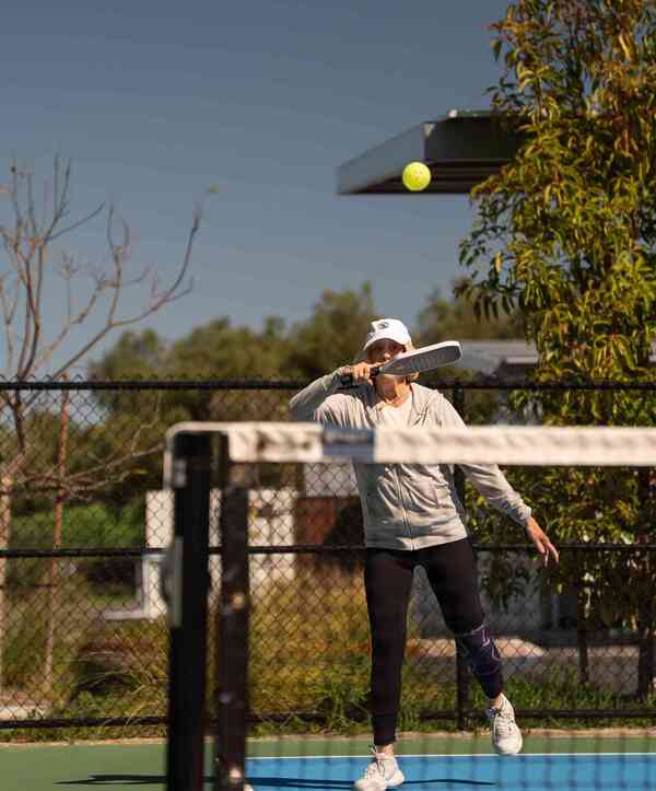 Accordion image Member playing pickleball.