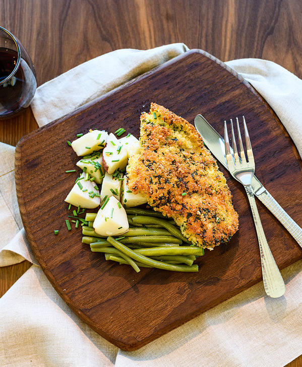 Fish and potatoes on a plate.