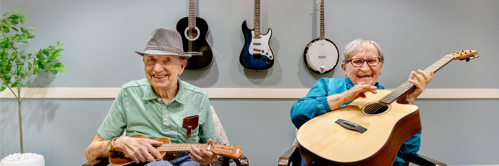 Two people playing guitars at The Watermark at Bellevue, a memory care community in Bellevue, WA. Two people playing guitars at The Watermark at Bellevue, a memory care community in Bellevue, WA.