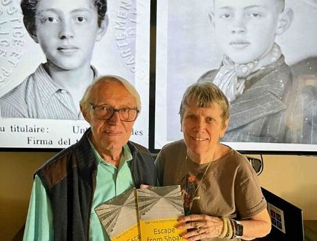 Bernie and his wife holding his book. Escape from Shoah.