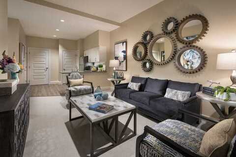 The Preston of The Park Cities decorated living room with sofa, chair and an entertainment center