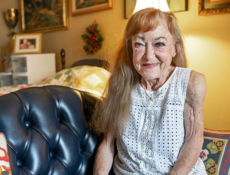 A person sitting on the couch smiling.