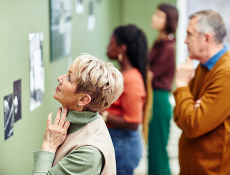 A resident is looking at photo in museum