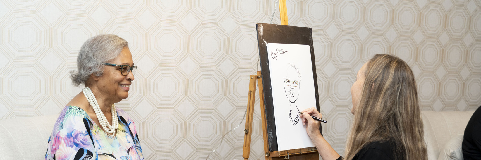 Resident getting her caricature drawn