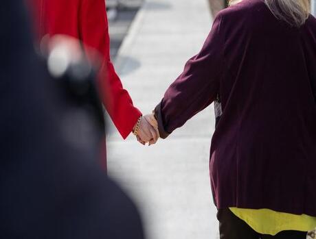 Two people holding hands.