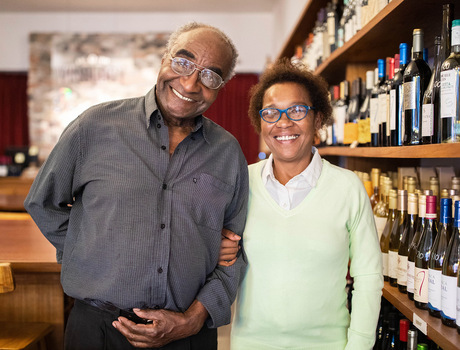 Couple pose with wine.