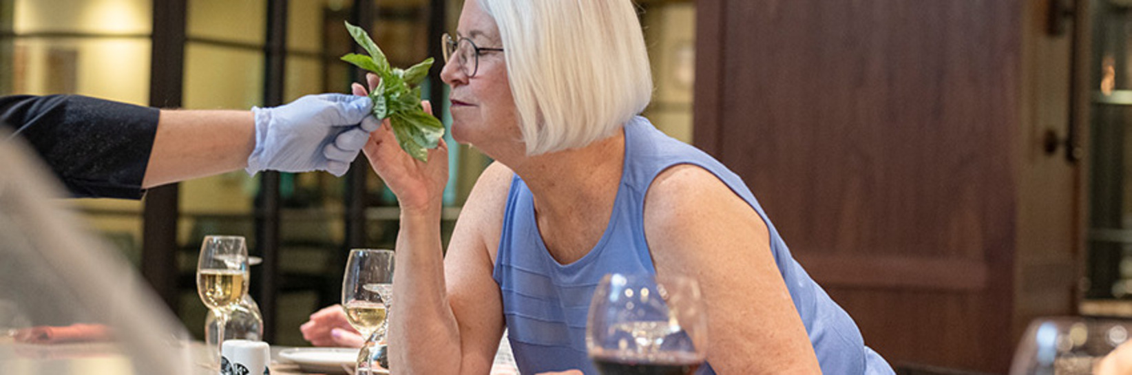 A person smelling an herb.