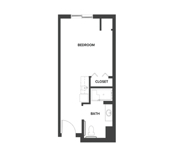 An assisted living studio suite floor plan with an open living/bedroom space and kitchenette.