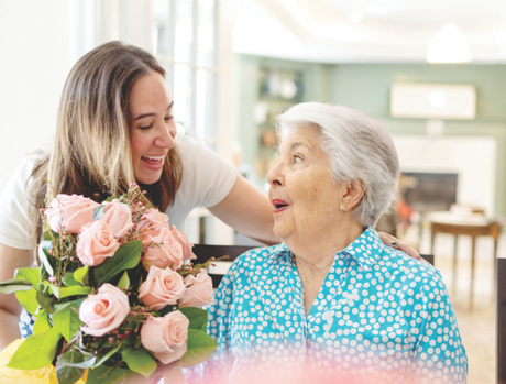 Two women laughing at table.