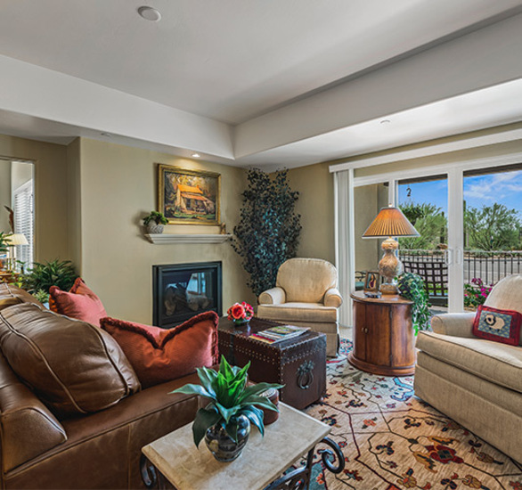 Furnished living room space with sofa, table, and seating area.