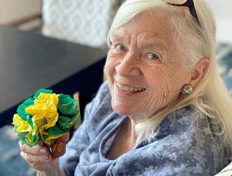 A resident is holding flowers.