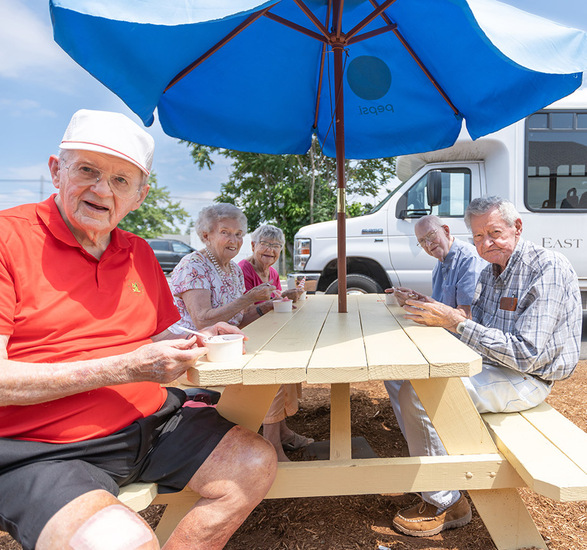 Residents are having ice cream together outside.