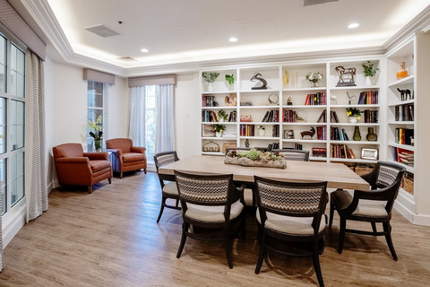 A common area with book shelves and a table.