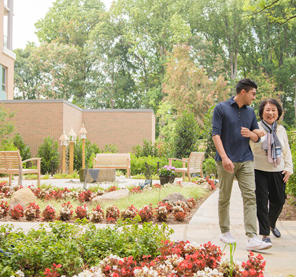 A resident is walking with a family member.