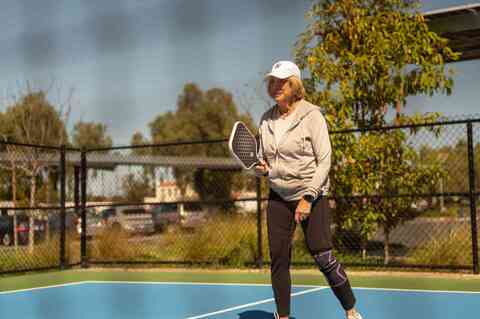 Resident playing pickleball 