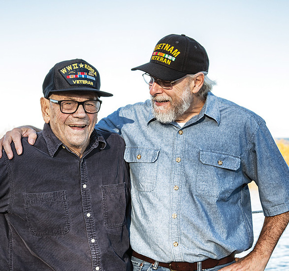 Two air force veterans by a lake.