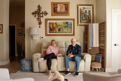 Two people sitting on the couch.
