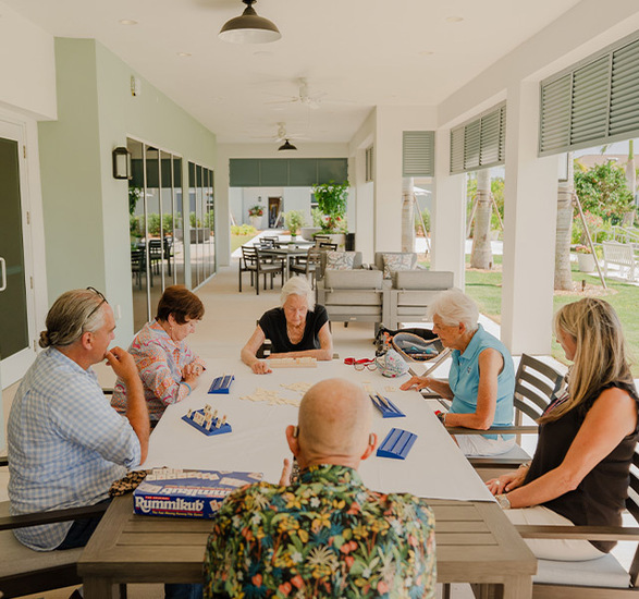 People at a table playing a game.
