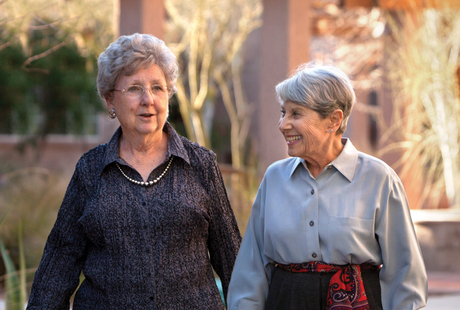 Two residents smiling while walking outside.