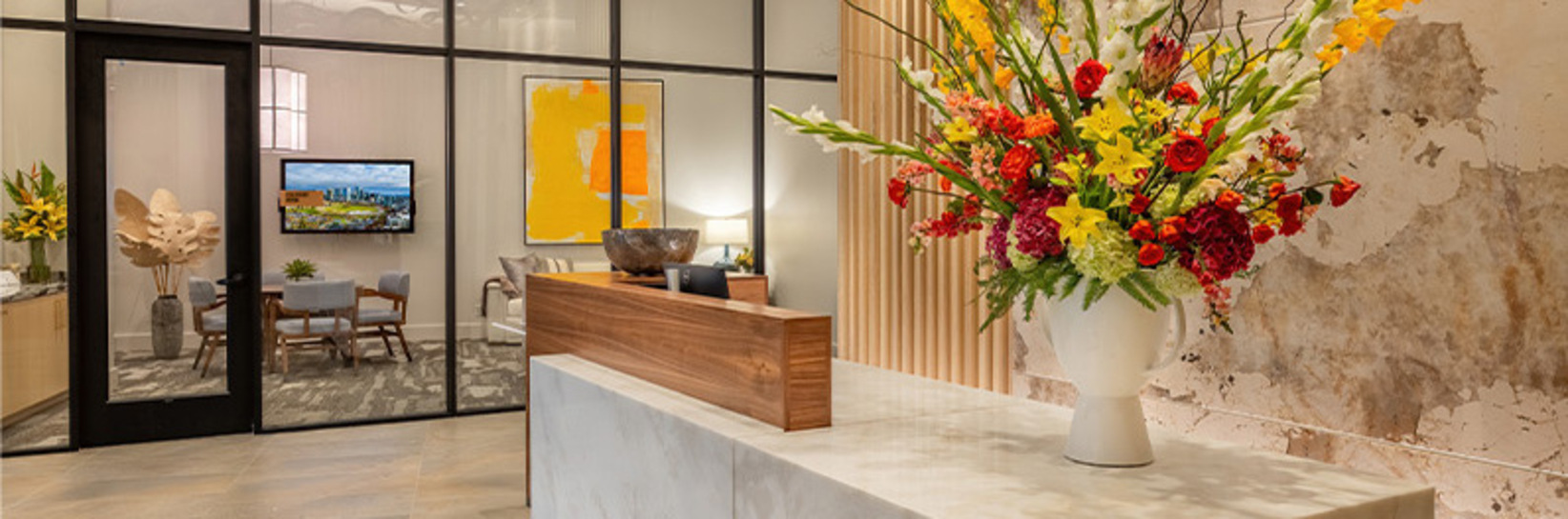 A front desk with a large floral arrangement on it. A front desk with a large floral arrangement on it.