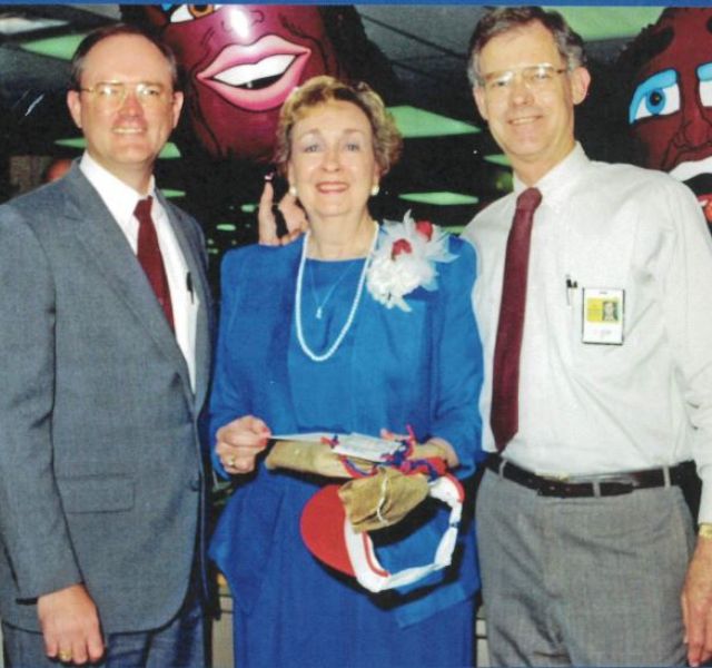 Three co-workers smiling