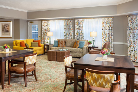 Furnished living room space with sofa, table, and seating area.
