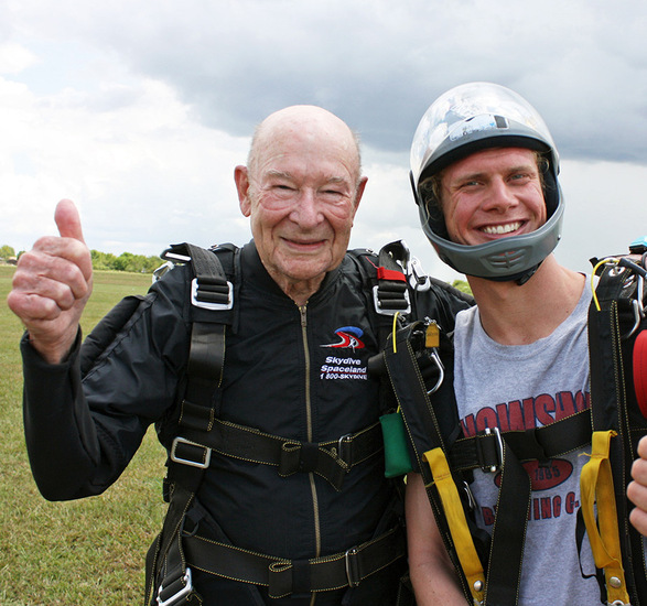 A resident is sky diving with a family member.