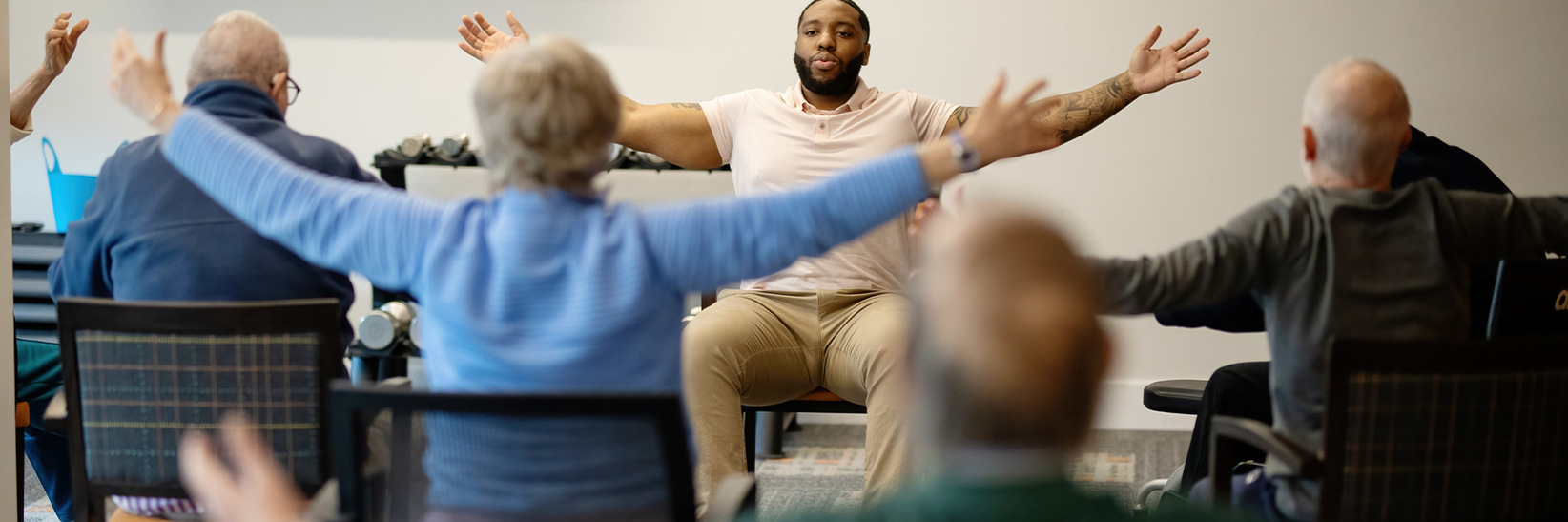 People in a seated exercise class.