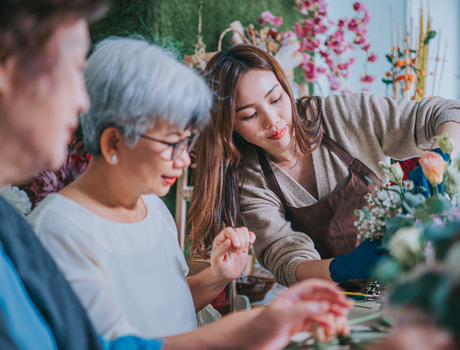 People arranging flowers in a class.