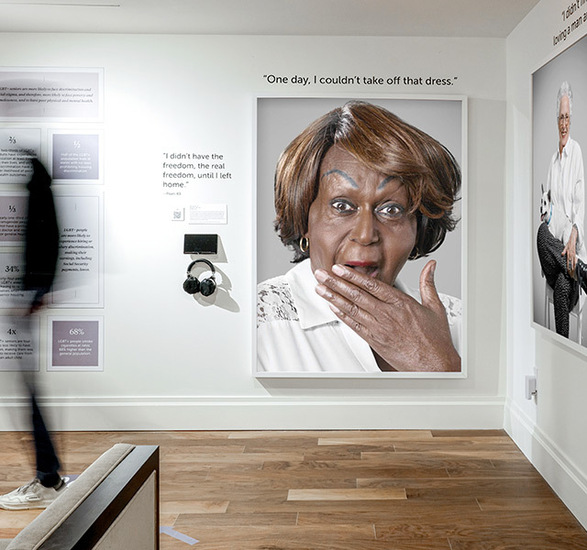 A person walking by a photo exhubit.
