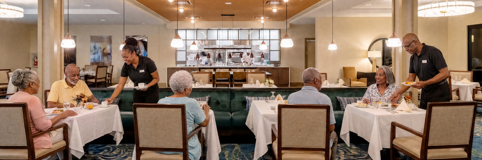 The Mark restaurant at The Sky Bridge at Town Center. Residents enjoy dinner while wait staff serve meals. The Mark restaurant at The Sky Bridge at Town Center. Residents enjoy dinner while wait staff serve meals.