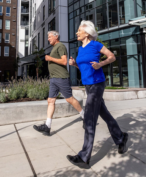 Two people jogging outside. Two people jogging outside.