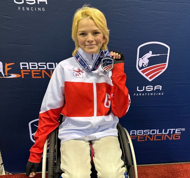 Cora is showing her medal at the Paralympics.