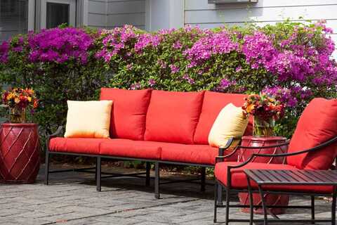 Red patio chairs in courtyard.