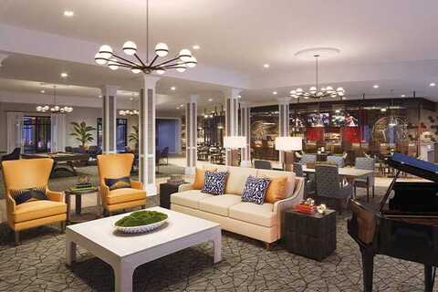 A lobby with seating and a piano.