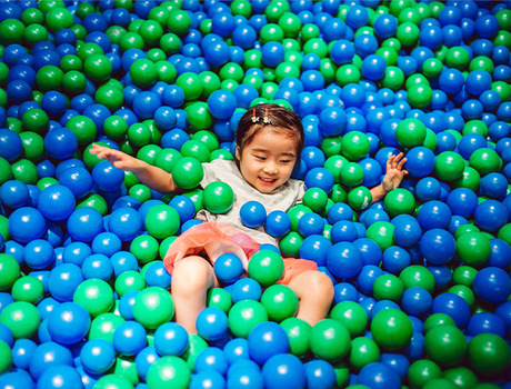 A child in a ball pit.