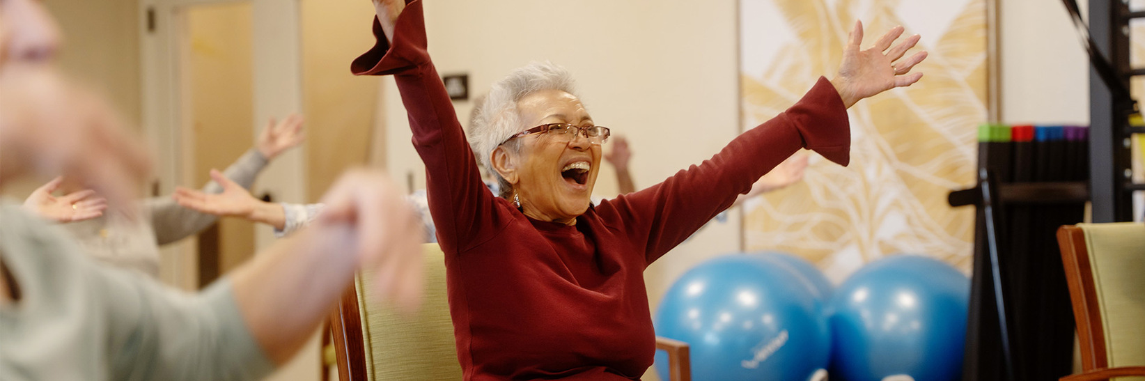 An assisted living resident at The Hacienda Mission San Luis Rey senior living community celebrates.