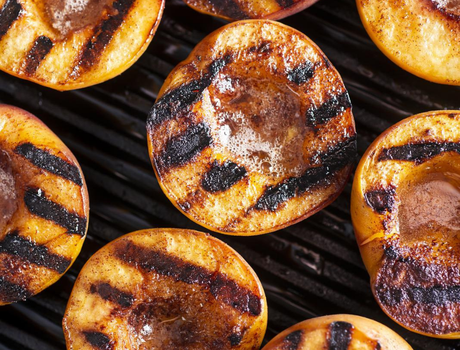 Grilled peaches on grill