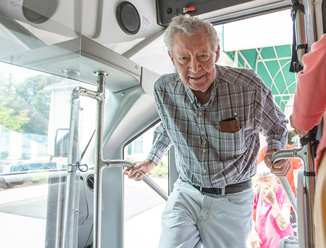 A resident is getting on a bus.