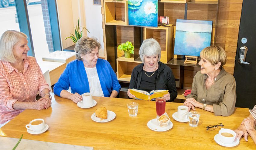 Ladies are meeting for book club.