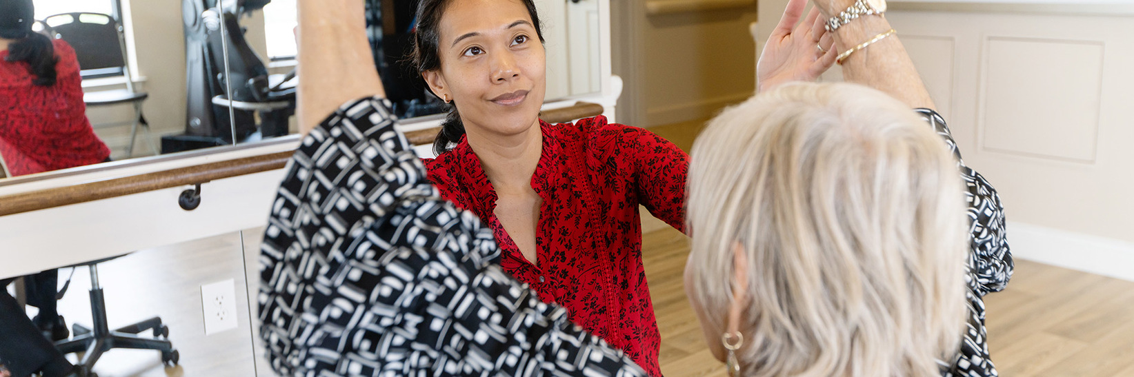 A resident working with a physical therapist.