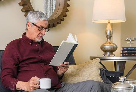 A person having coffee and reading the paper.