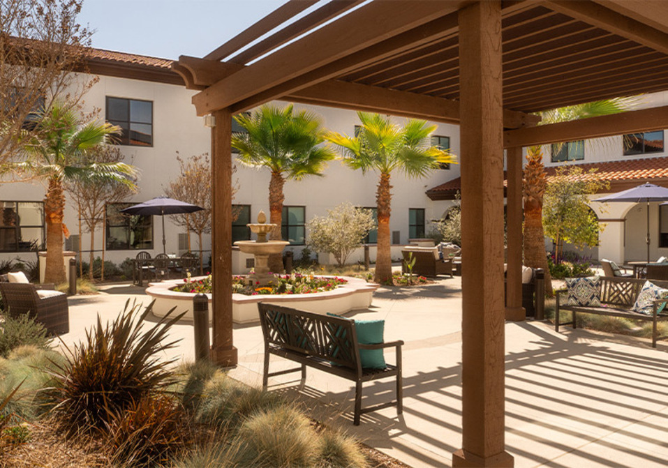 A courtyard with seating at The Hacienda Mission San Luis Rey.