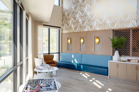 A sitting area with a long blue couch.