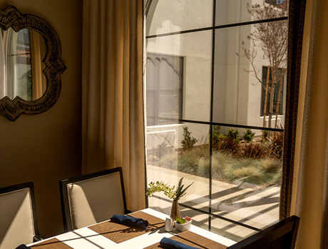A dining table by a window.