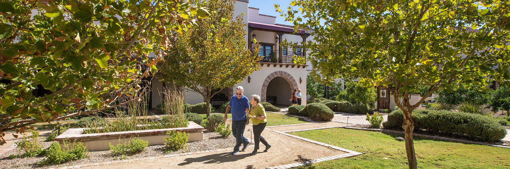 Two members walking through The Hacienda at the River courtyard. Two members walking through The Hacienda at the River courtyard.